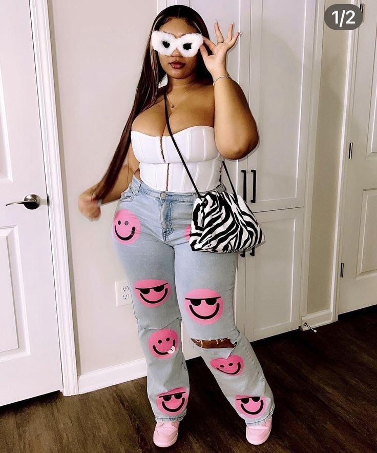 Black plus size woman in blue jeans with pink smiley faces on them. Wearing a white corset and zebra handbag.